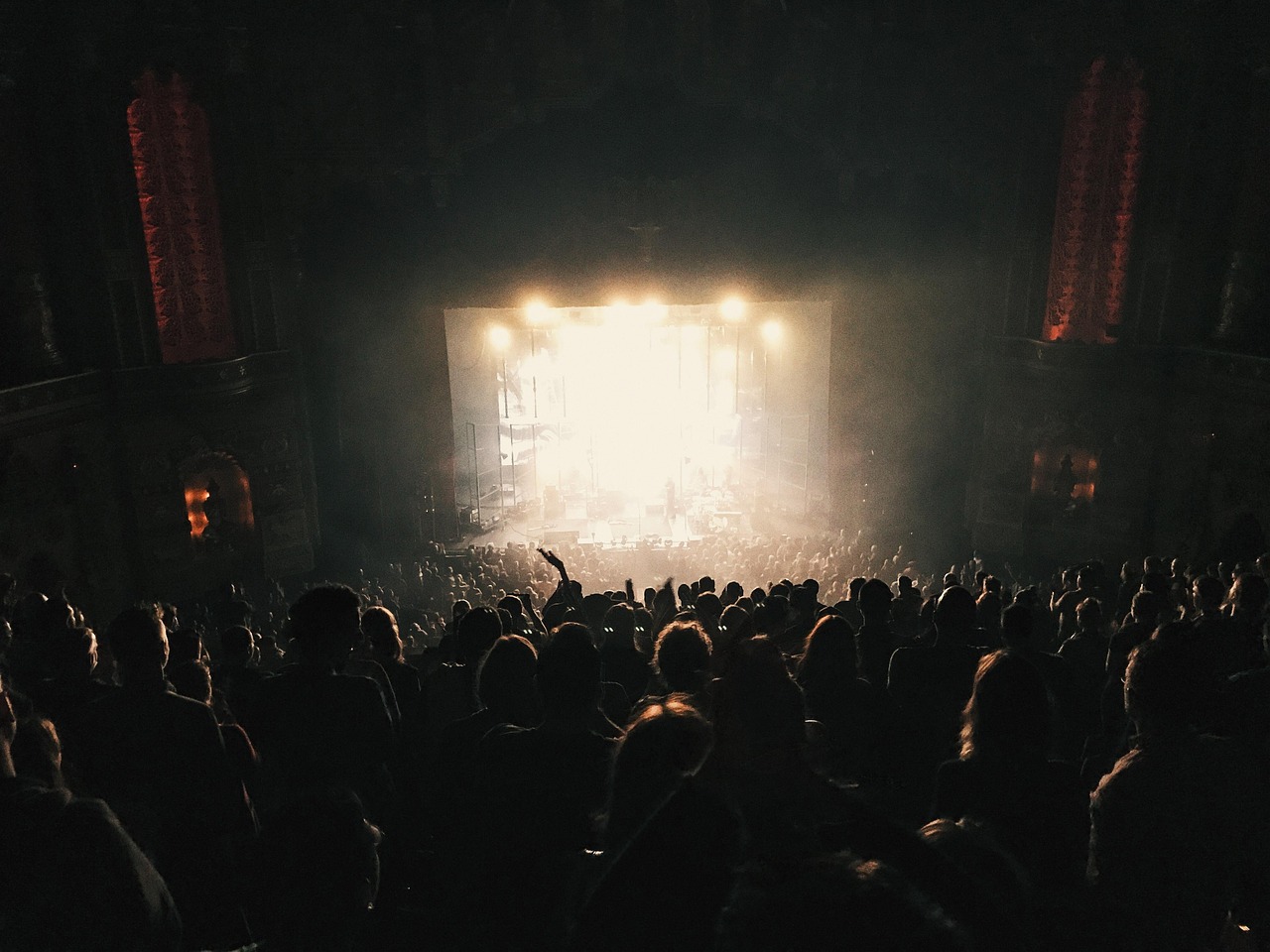 Audience silhouetted against the stage lights
